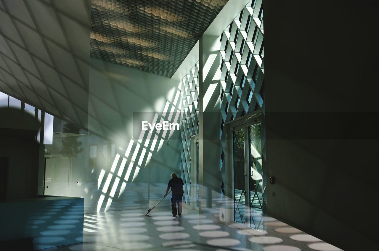 Man walking in corridor of building