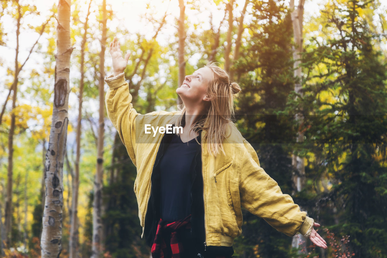 YOUNG WOMAN LOOKING AWAY IN FOREST