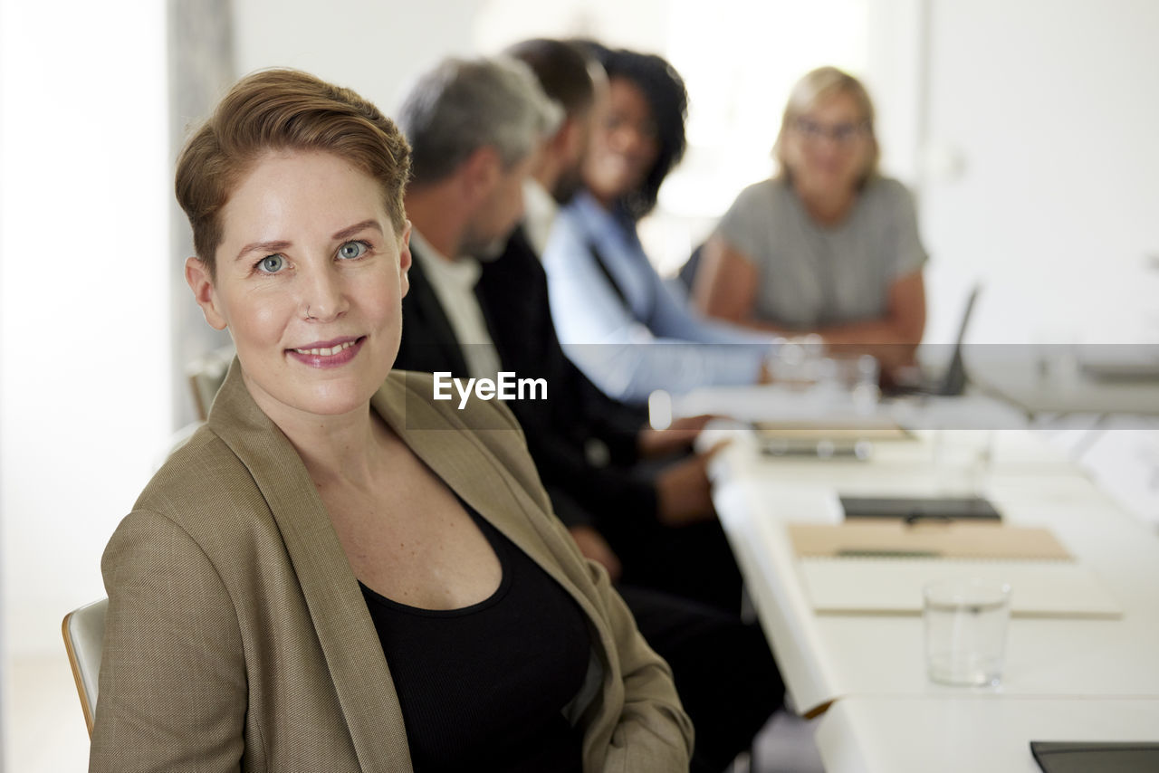 Smiling businesswoman in boardroom
