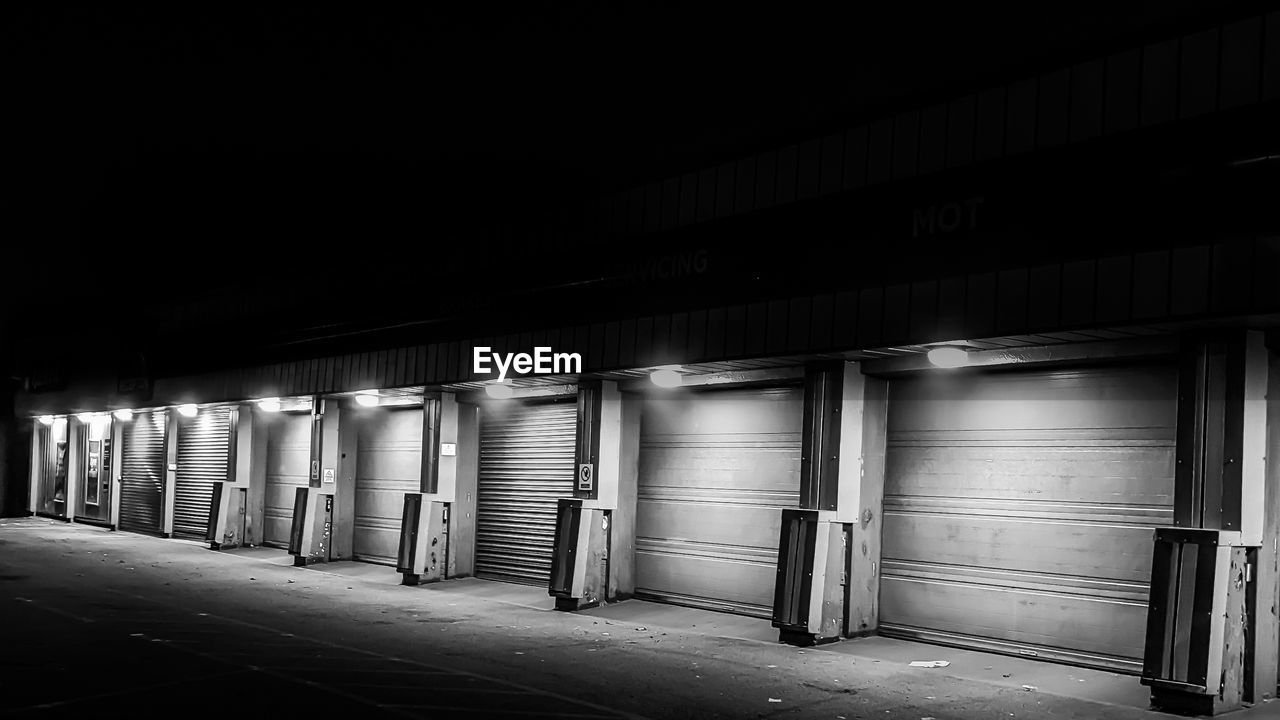 darkness, black, architecture, black and white, white, monochrome, built structure, light, monochrome photography, night, no people, building, illuminated, indoors, transportation, urban area, infrastructure, entrance, city, lighting, parking lot, dark, closed, warehouse, lighting equipment