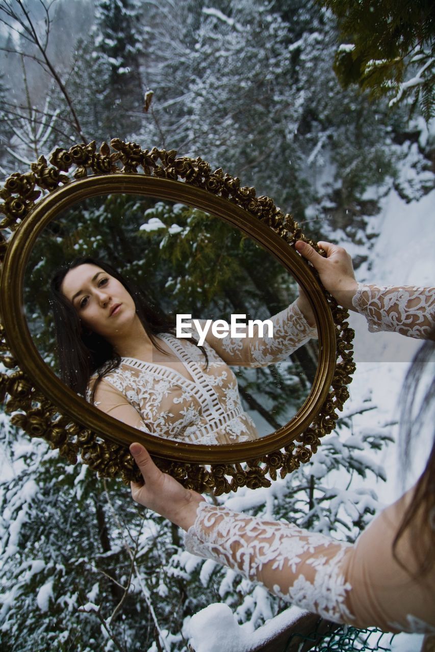 Close-up of woman holding mirror