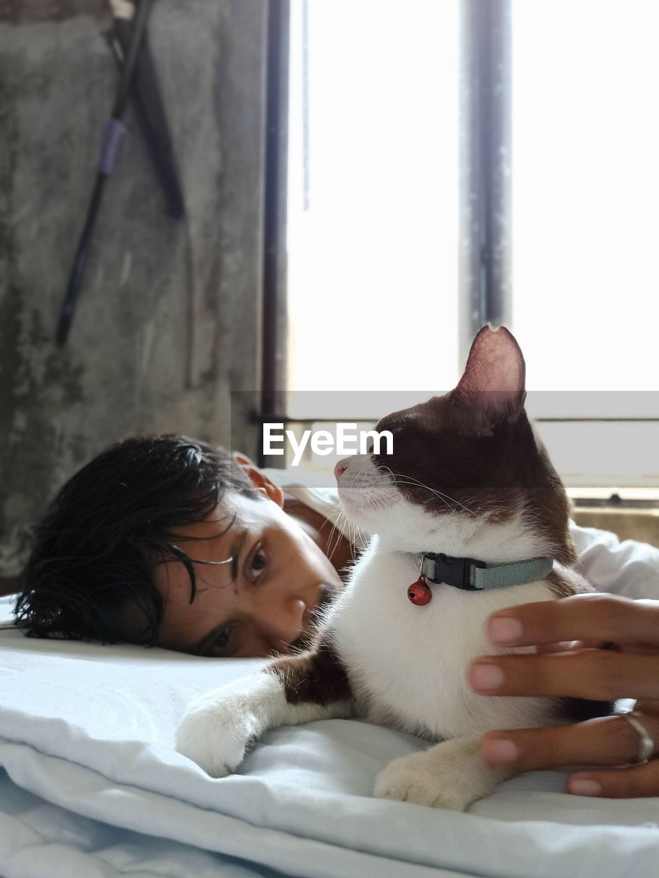 Portrait of young men with cat relaxing indoor