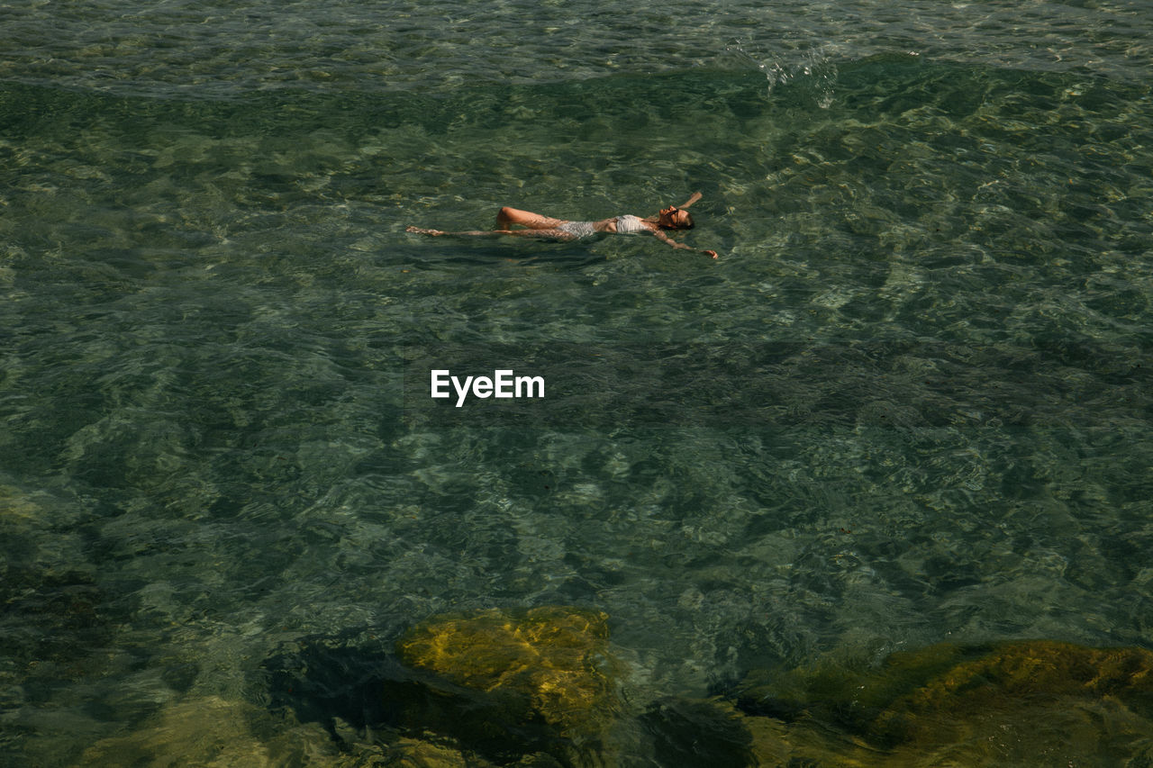 High angle view of lying down floating on water