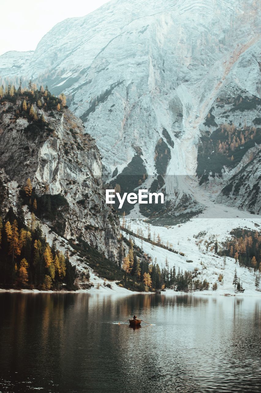 Scenic view of lake by snowcapped mountains