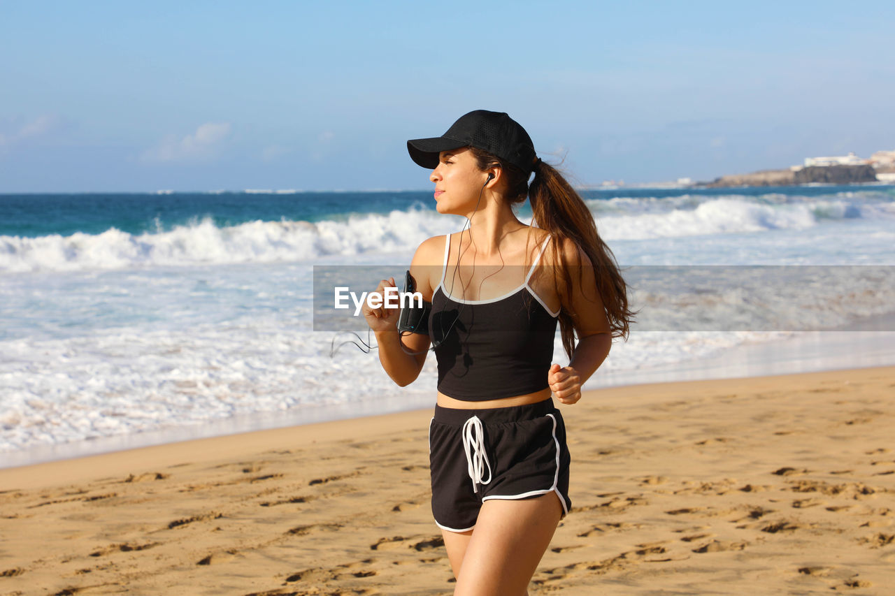 Young woman jogging at beach