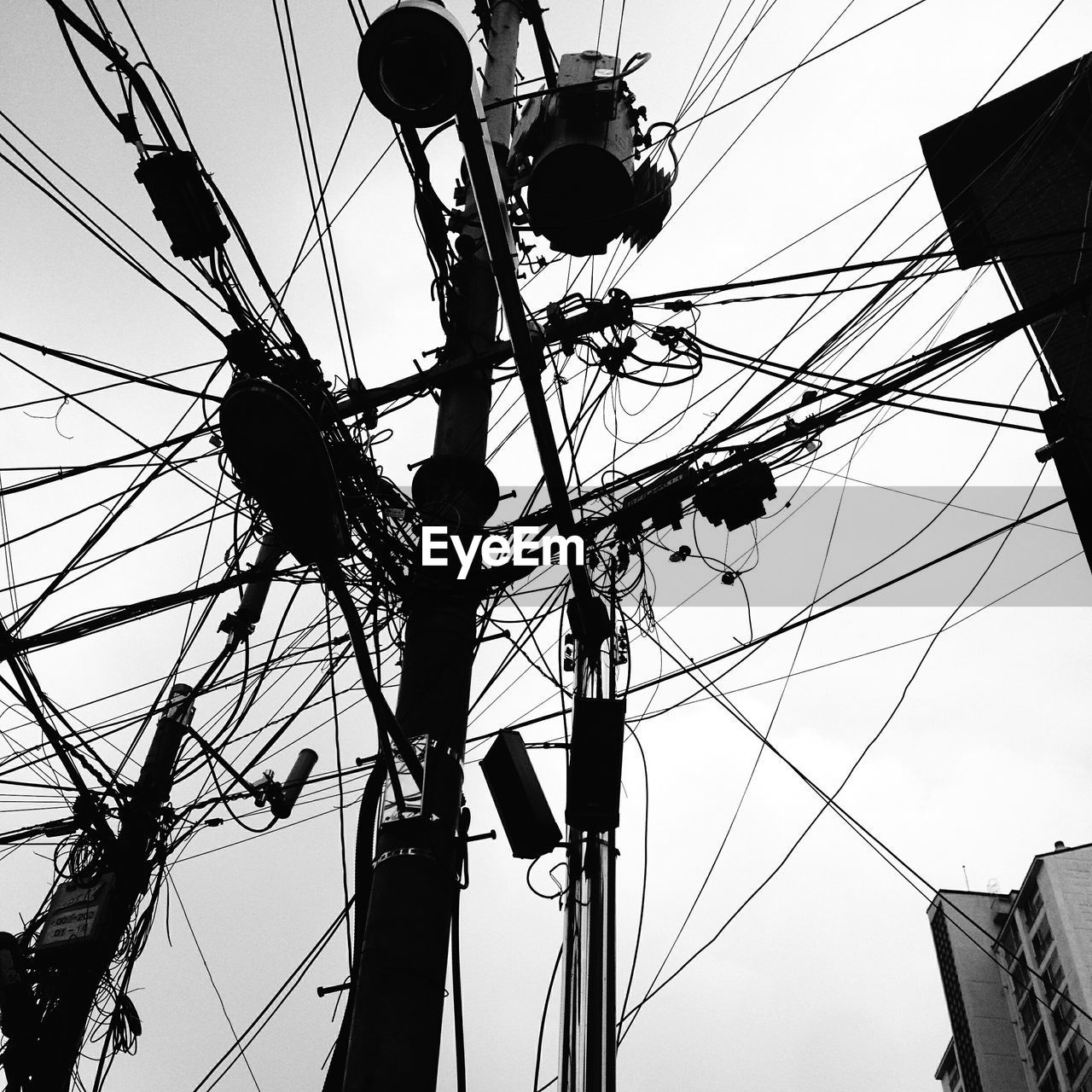 Low angle view of electricity pylons against sky