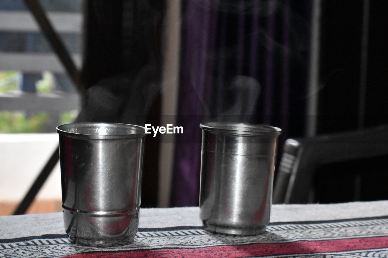 Close-up of tea cups on table at home