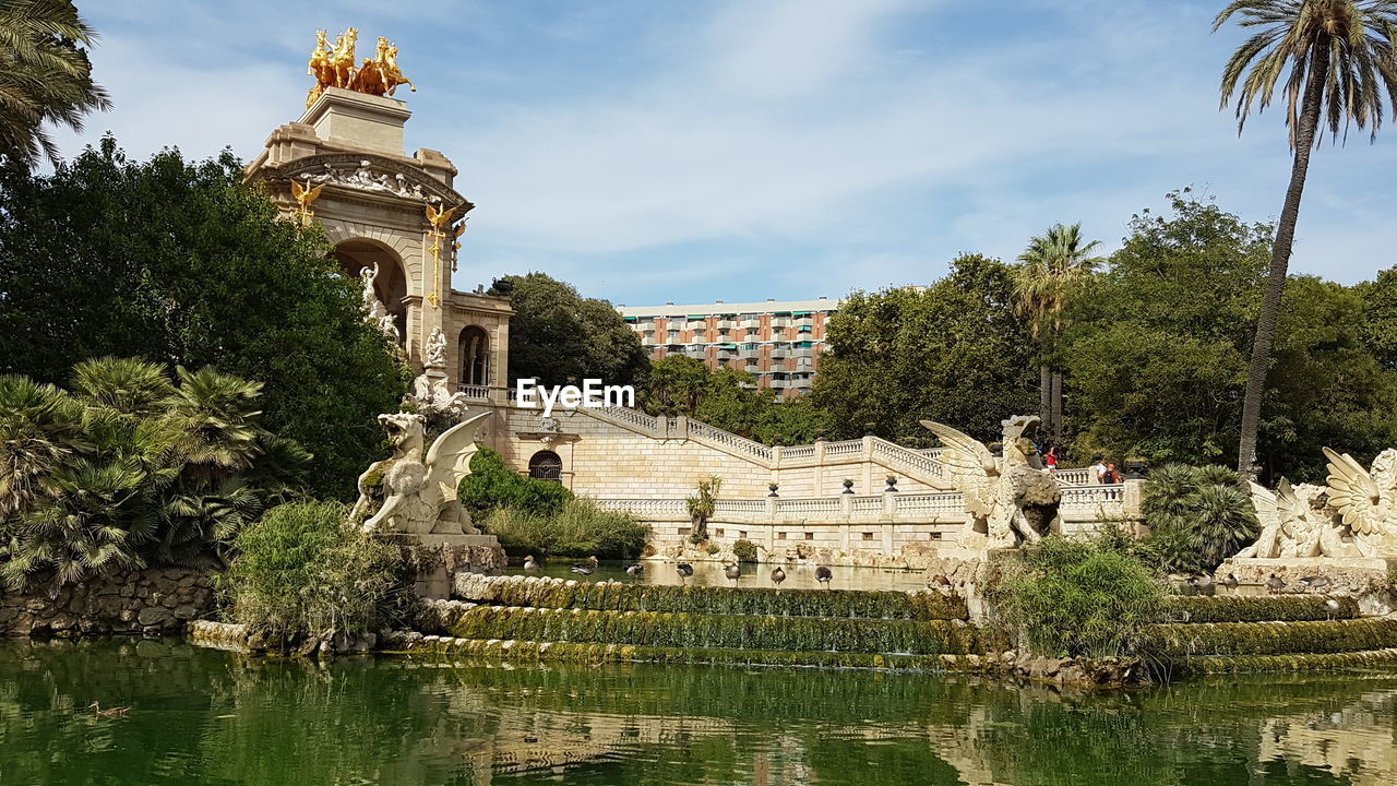 VIEW OF BUILDING BY LAKE