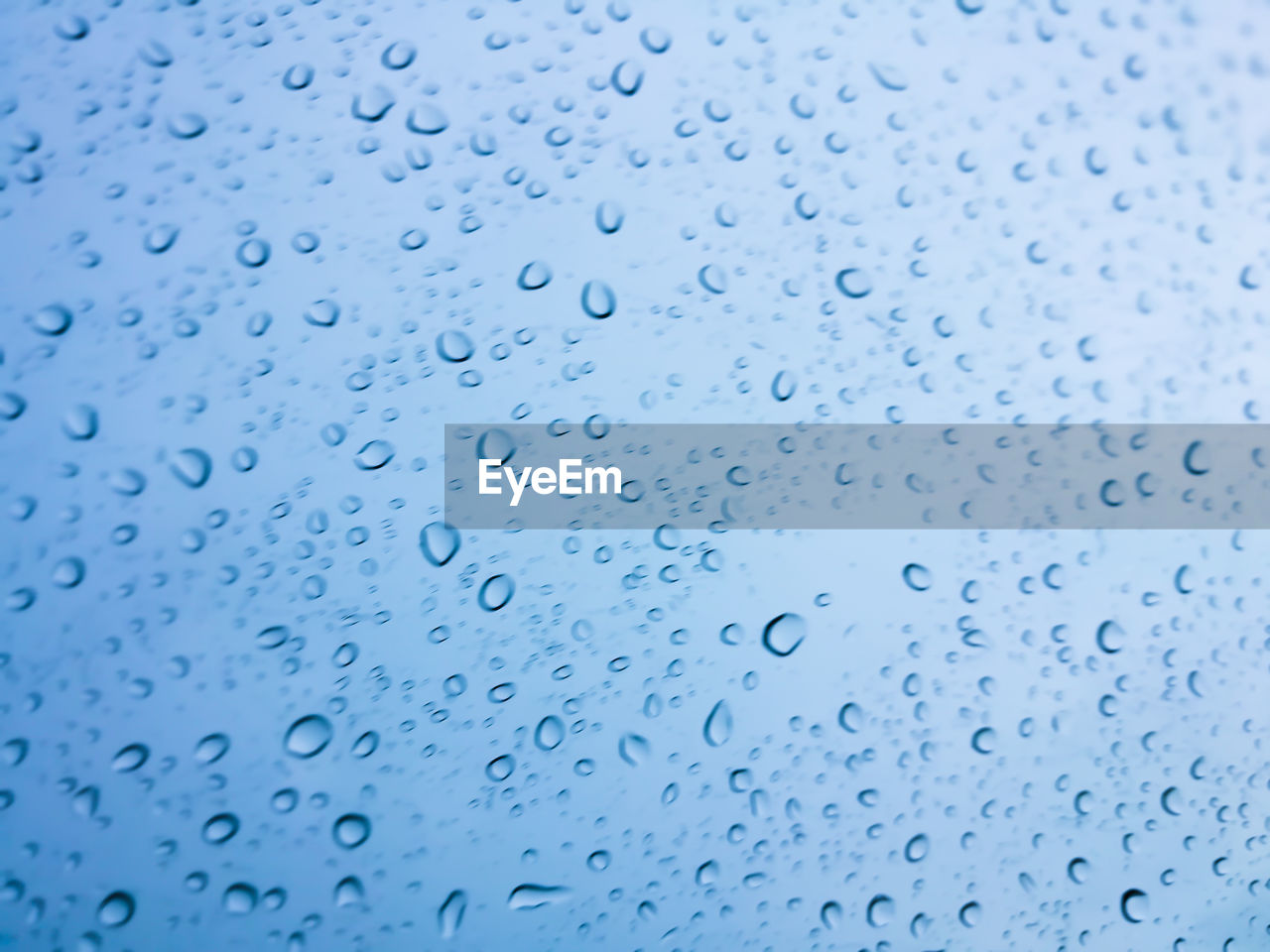 FULL FRAME SHOT OF RAINDROPS ON WINDOW