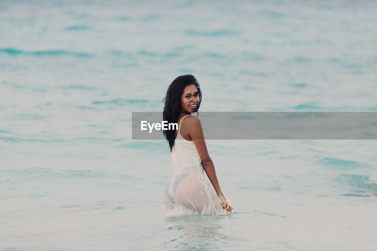 Happy young woman in the sea