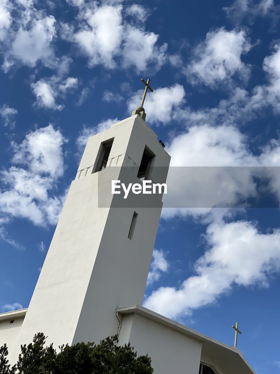 Low angle view of church belltower  against sky