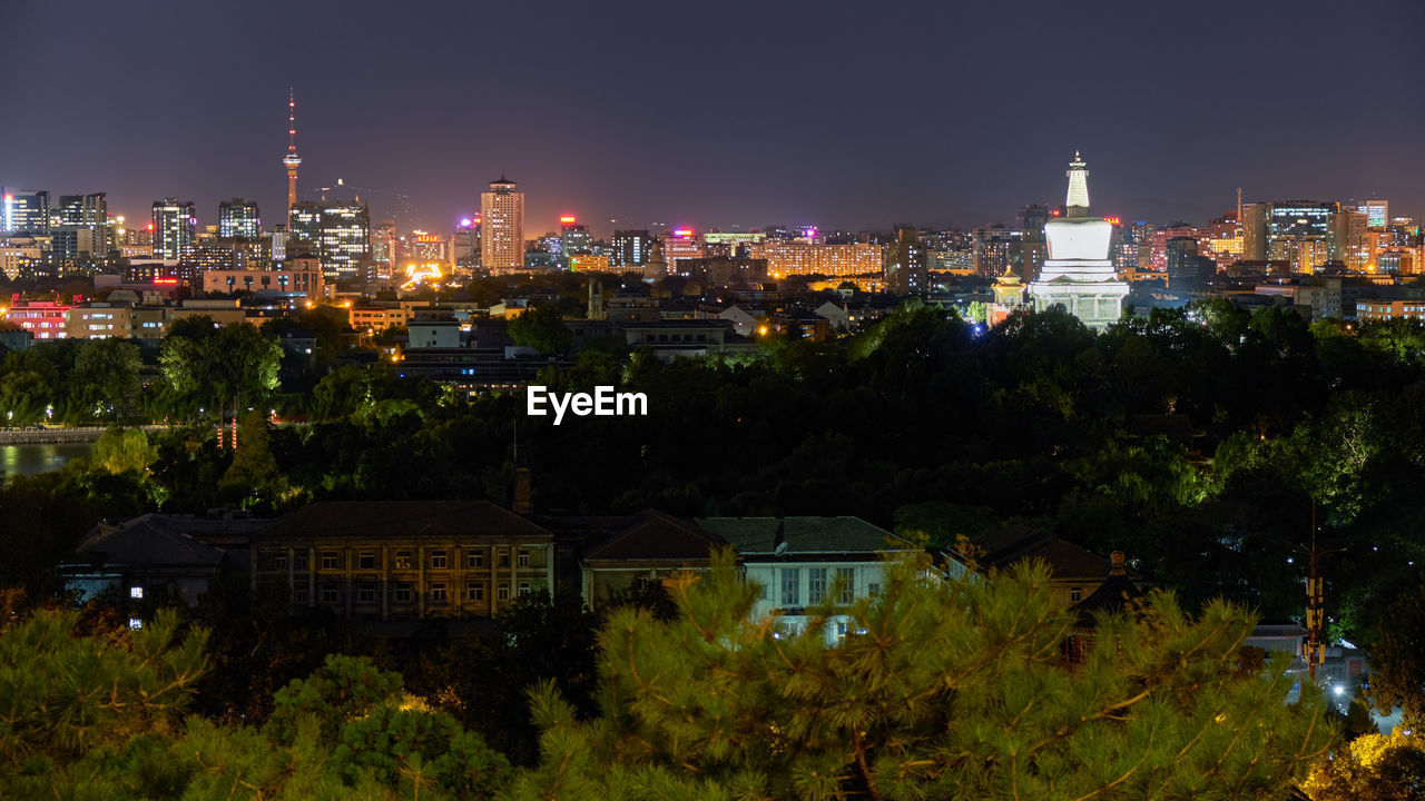 HIGH ANGLE VIEW OF ILLUMINATED BUILDINGS AGAINST SKY