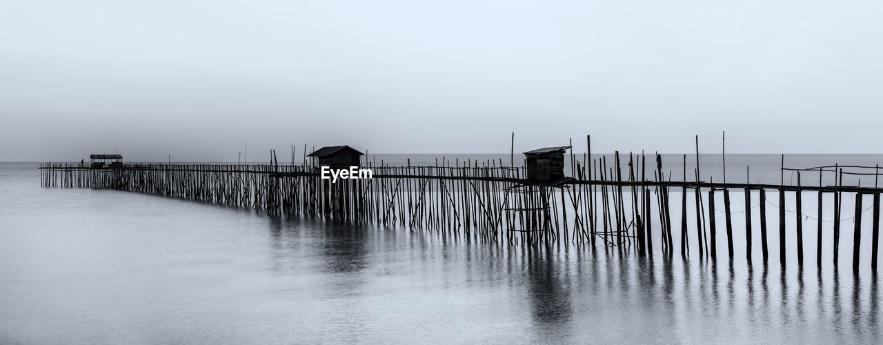 WOODEN PIER OVER SEA AGAINST SKY