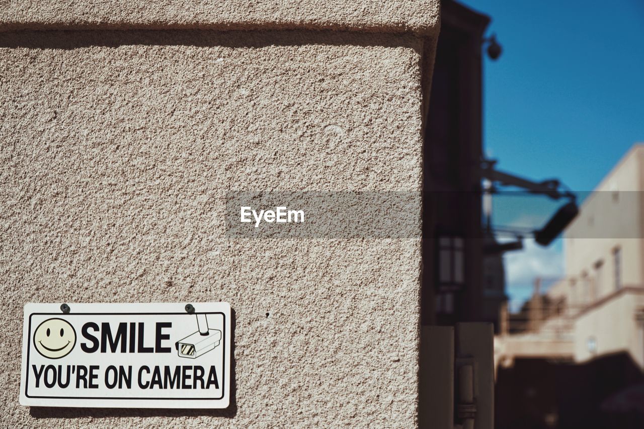 CLOSE-UP OF ROAD SIGN AGAINST BUILT STRUCTURE