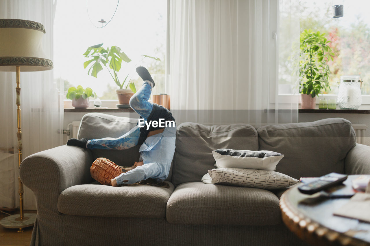 Girl playing on sofa  on the move