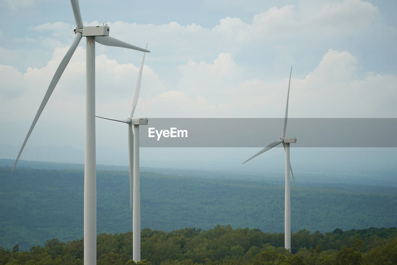 low angle view of windmills against sky