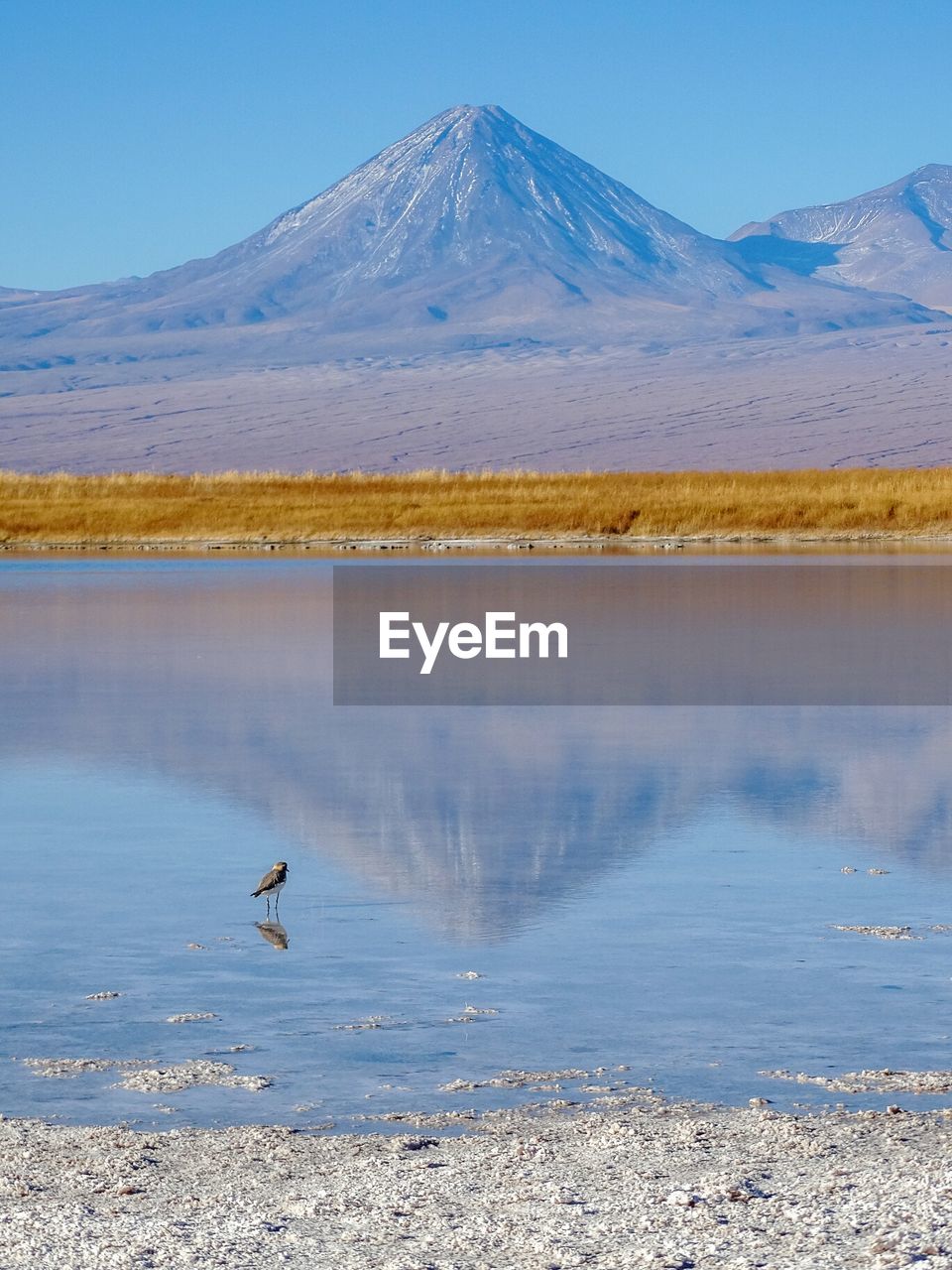 Scenic view of lake with mountain range in background