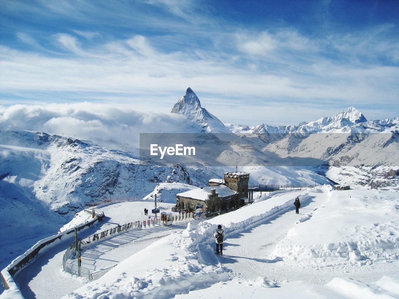 Snow covered gornergrat railway station and mountain against sky