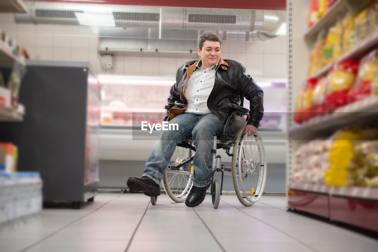 A disabled person in a wheelchair buys groceries