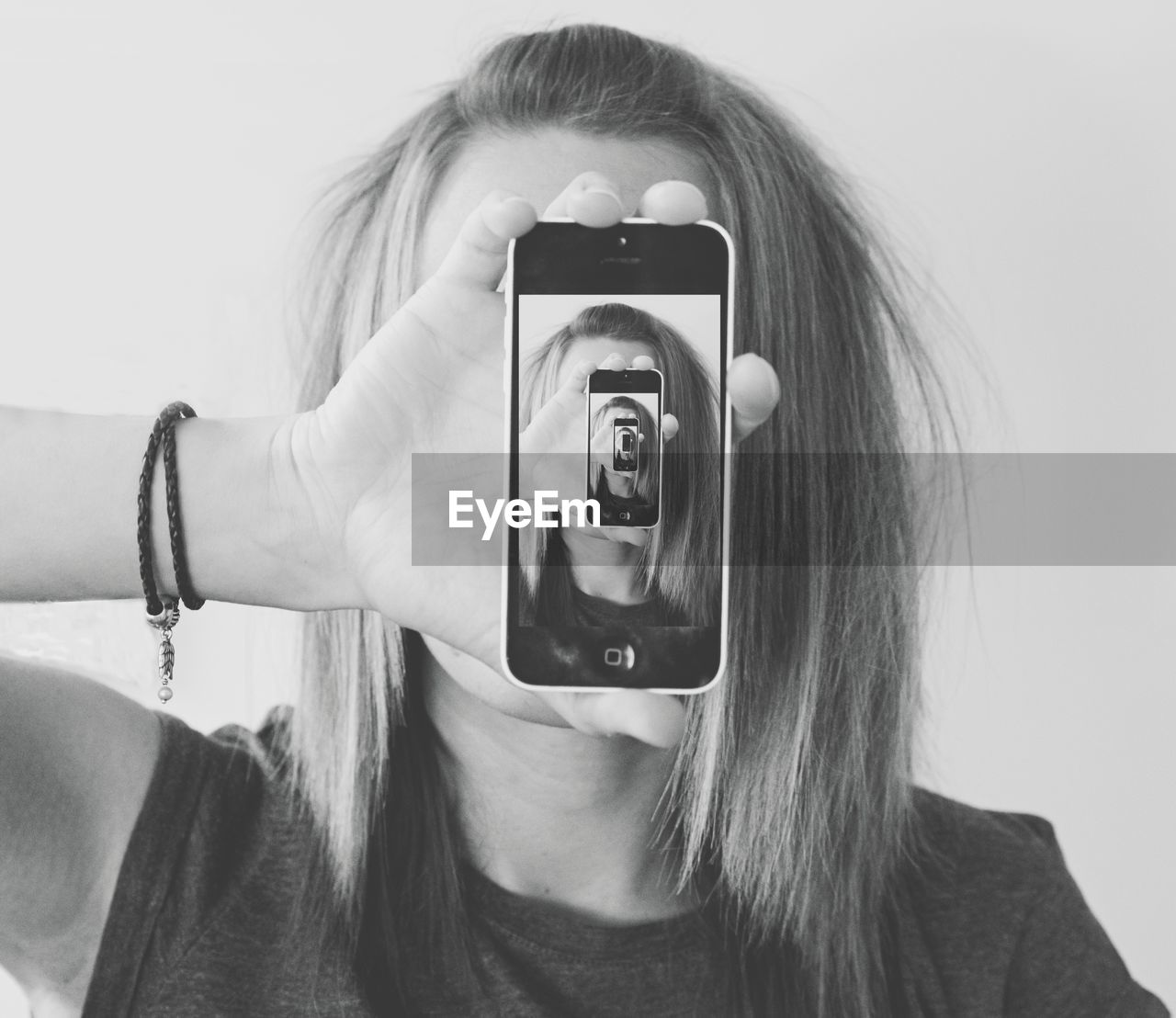 Close-up of young woman holding mobile phone