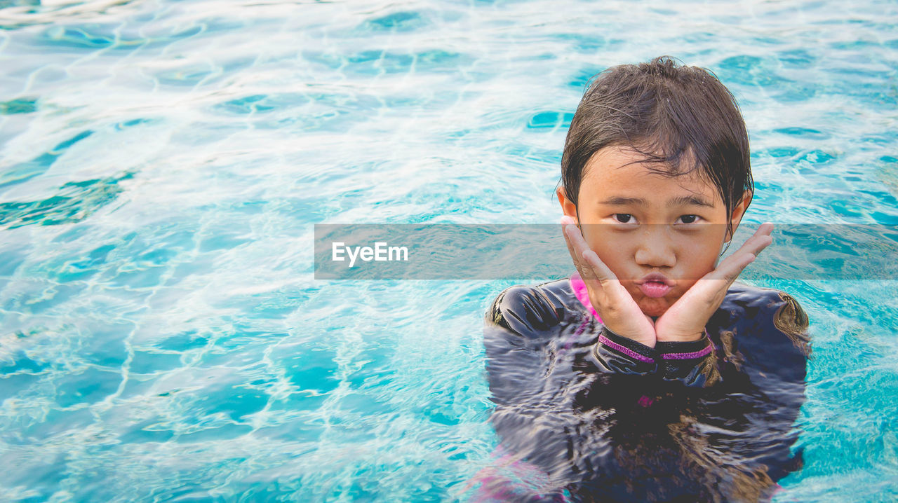 Portrait of smiling girl in swimming pool