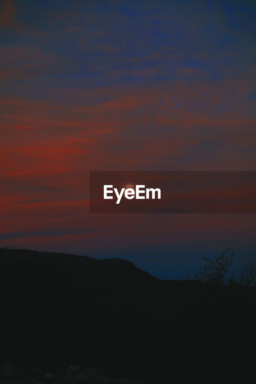 Scenic view of silhouette landscape against romantic sky at sunset