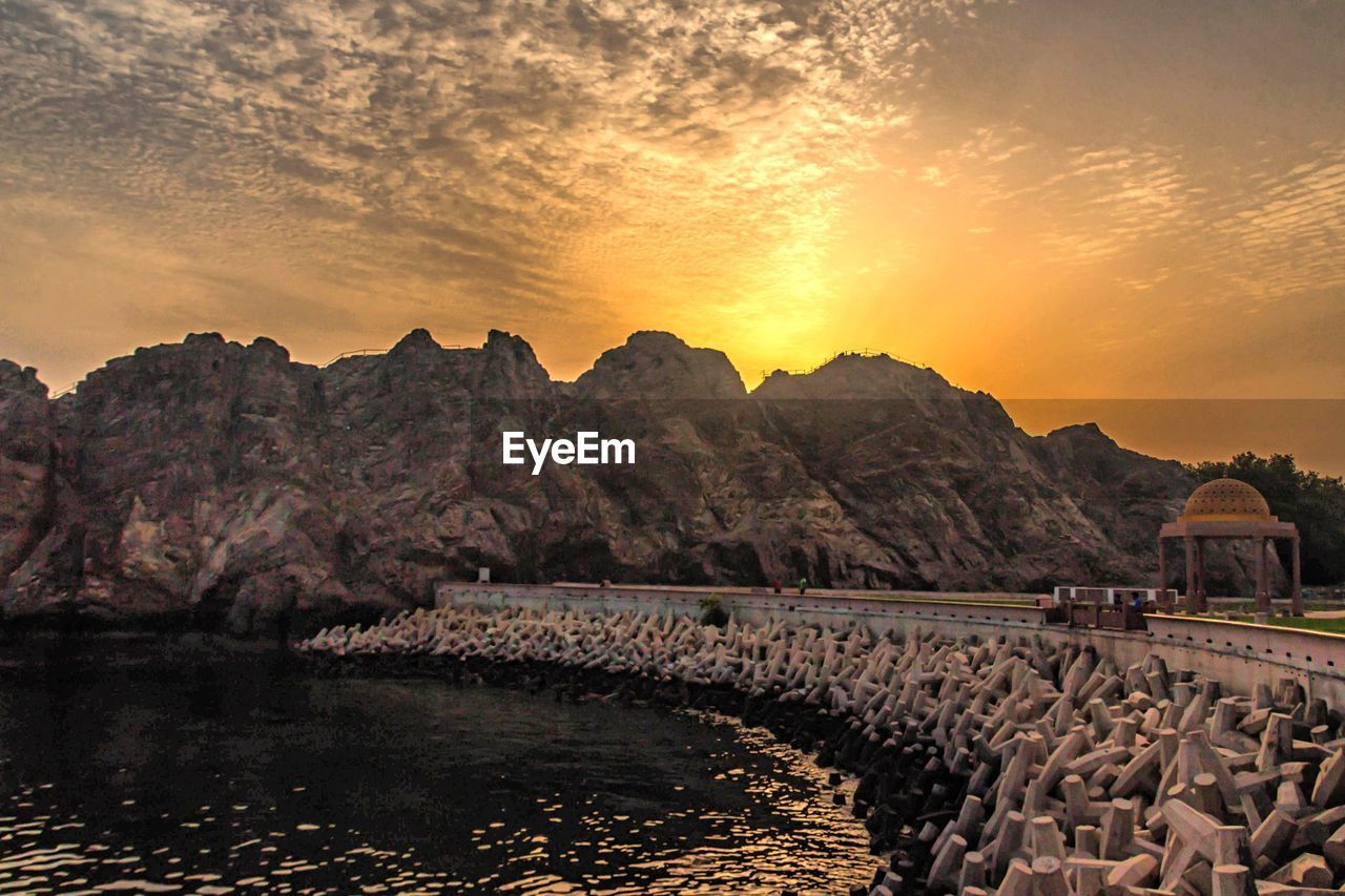 Scenic view of river against mountains during sunset