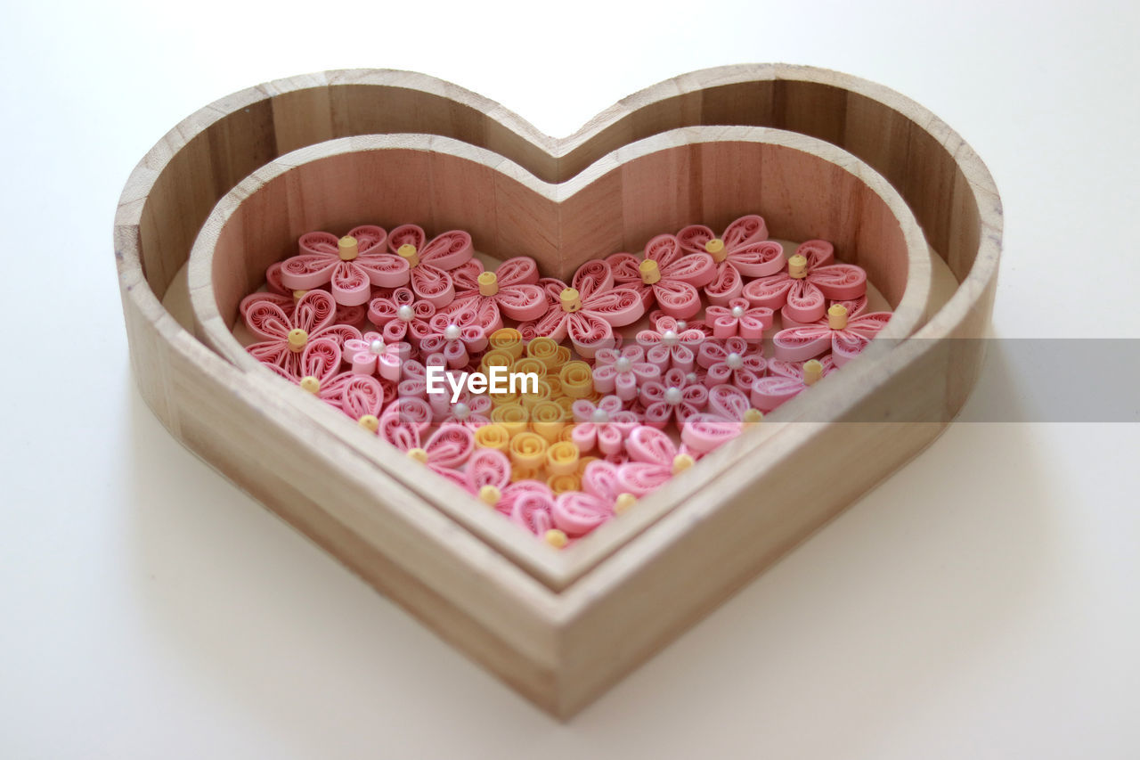 HIGH ANGLE VIEW OF HEART SHAPE MADE ON PINK BOARD