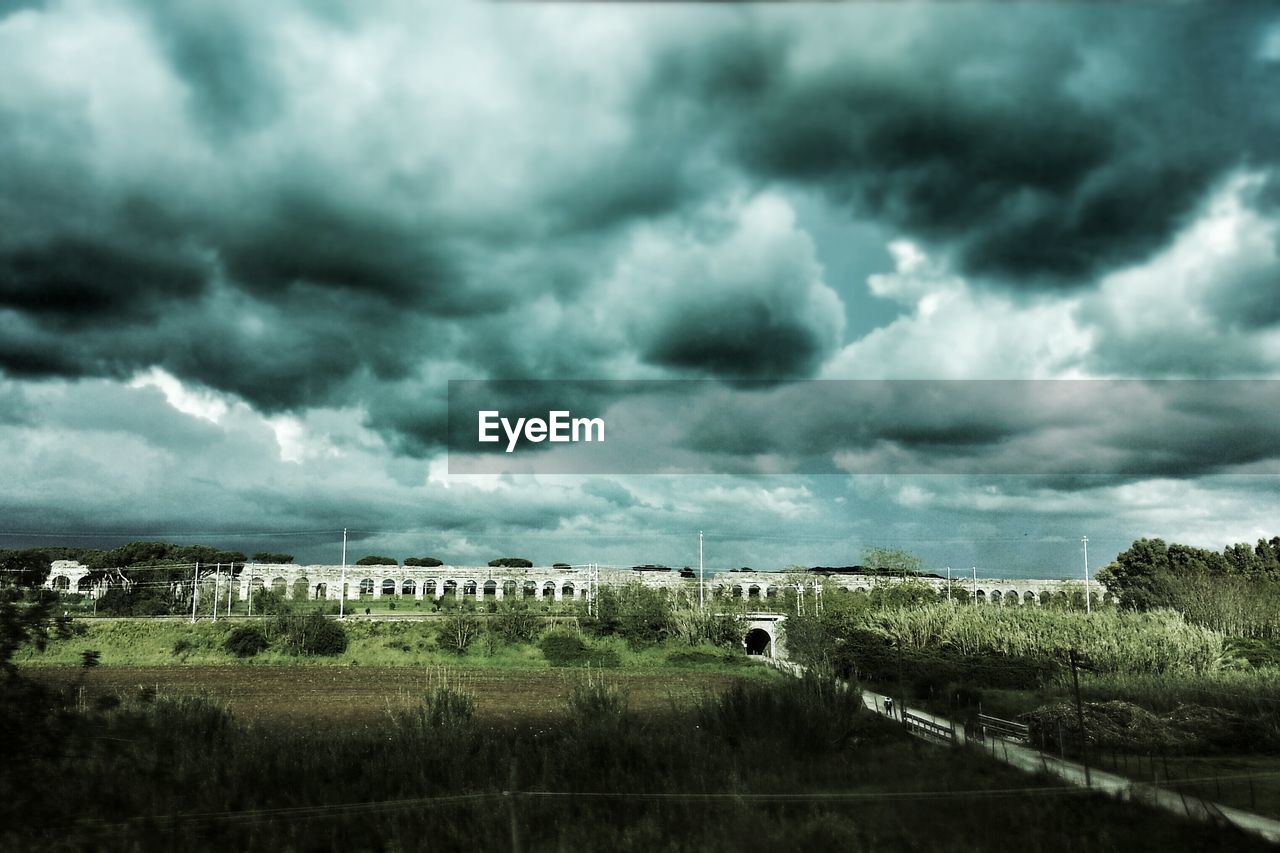 View of countryside landscape below cloudy sky