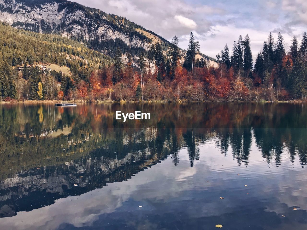 Reflection of trees in lake against sky