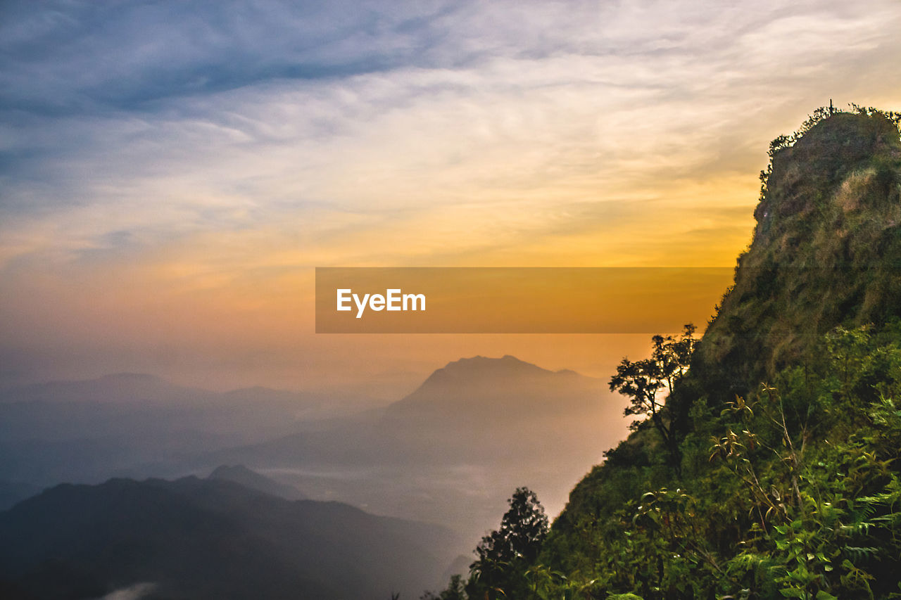 Scenic view of mountain against cloudy sky