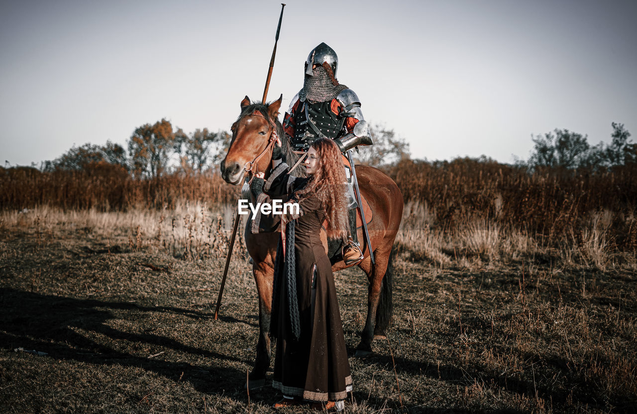 Person riding horse on field