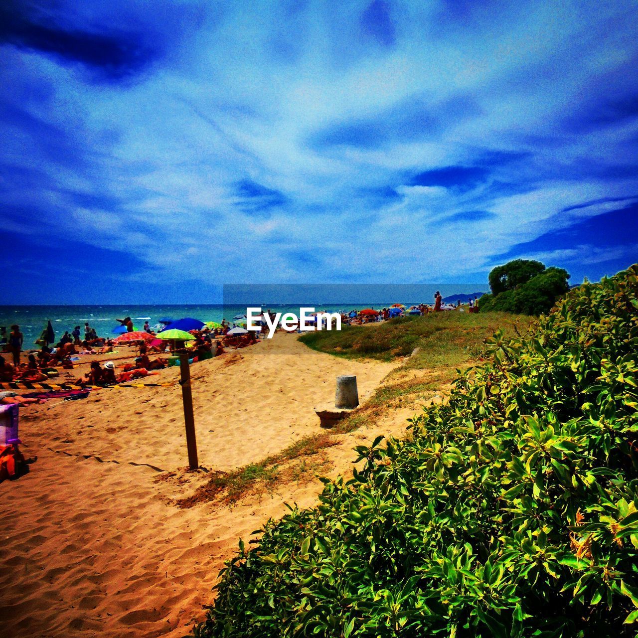 VIEW OF BEACH AGAINST CLOUDY SKY