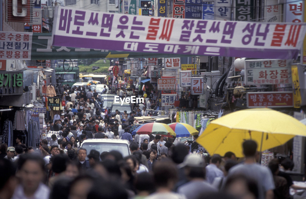 Crowd walking at market in city