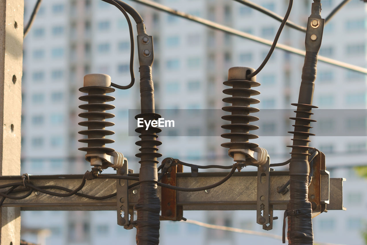 Close-up of insulator on electricity pylon