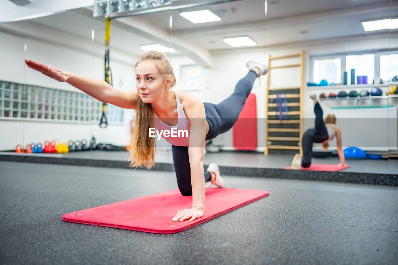 side view of man exercising in gym