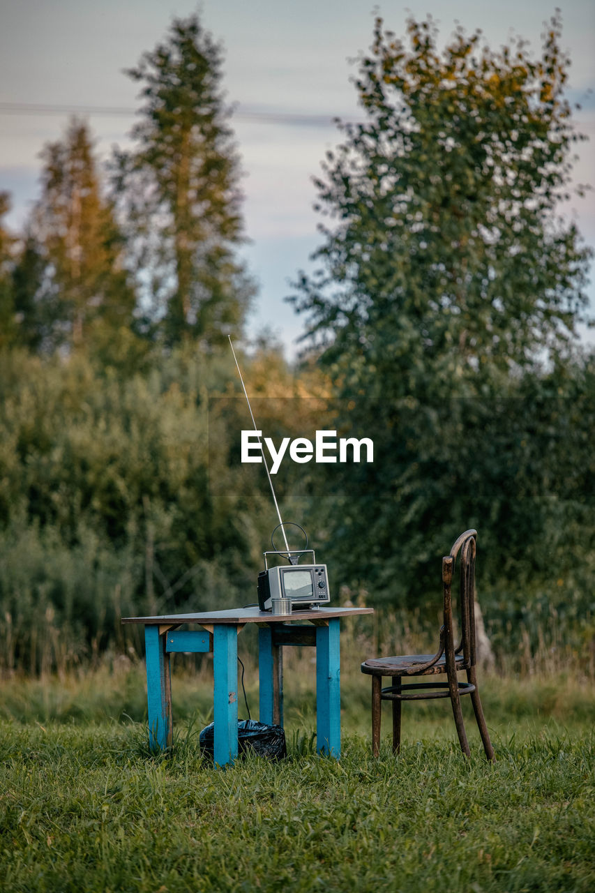 Vintage television set on table in forest