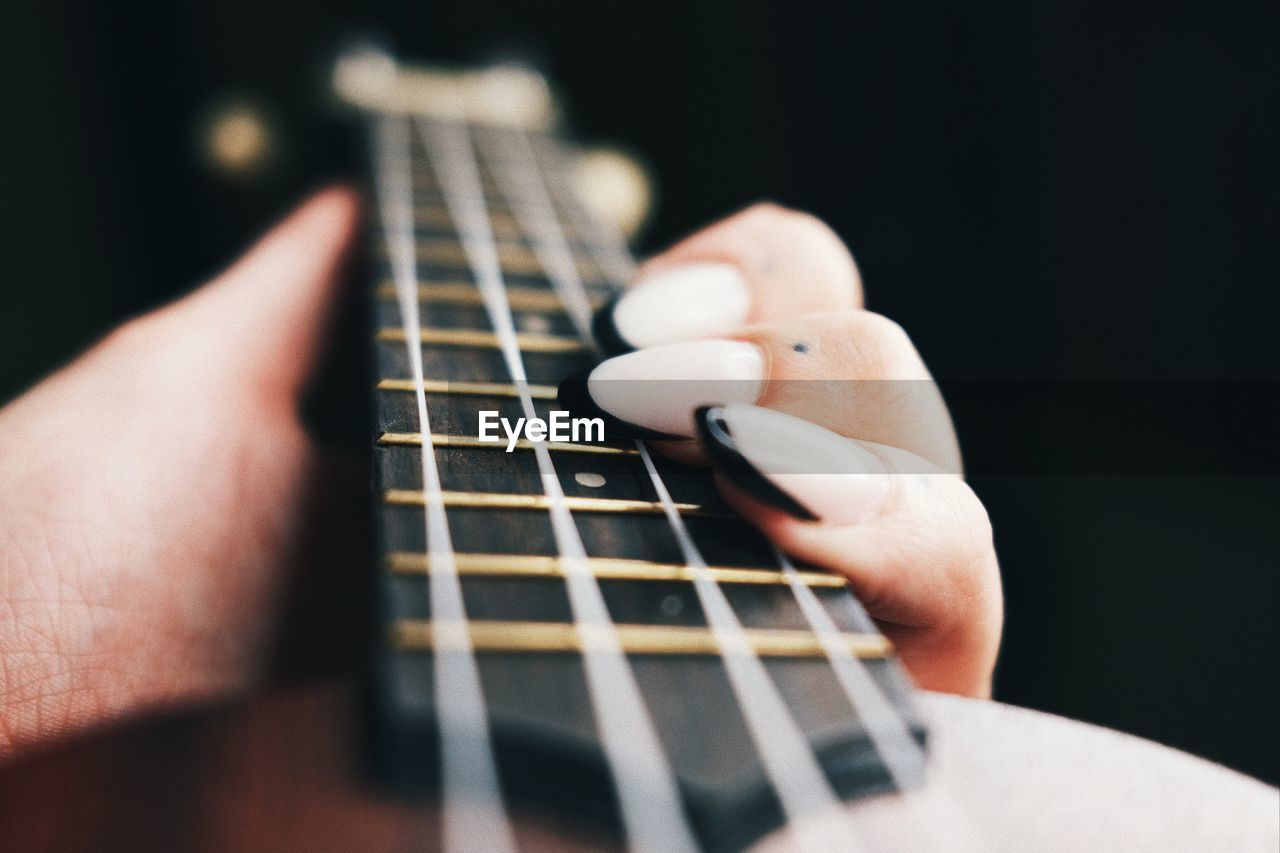 Close-up of hand holding guitar