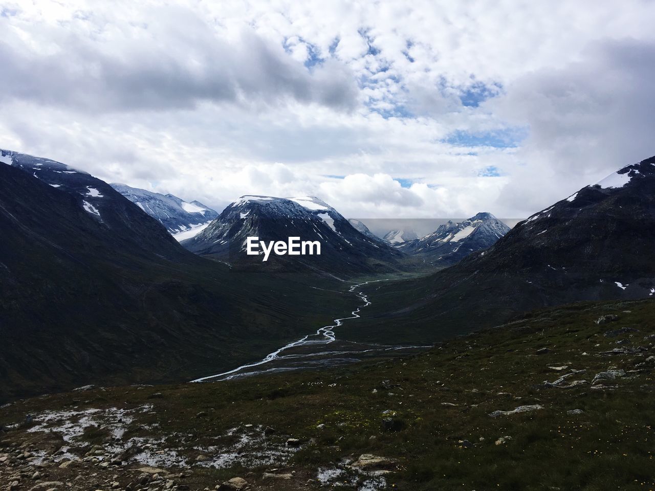 Scenic view of mountains against cloudy sky