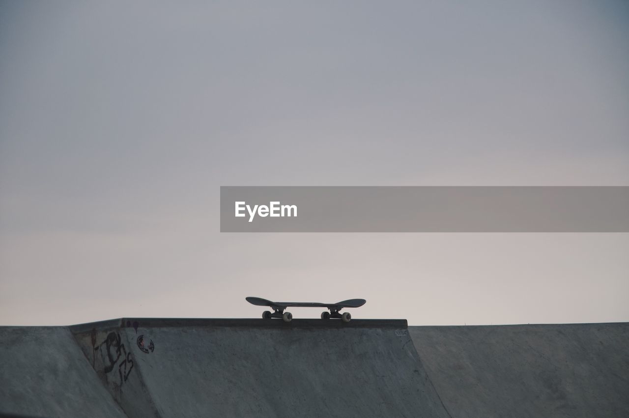 Skateboard at skateboard park against clear sky