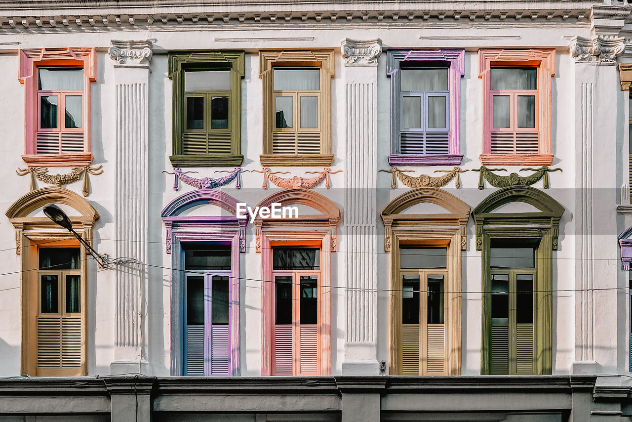 Low angle view of multi colored windows on building