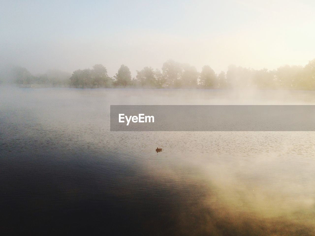 Scenic view of reservoir against sky during foggy weather