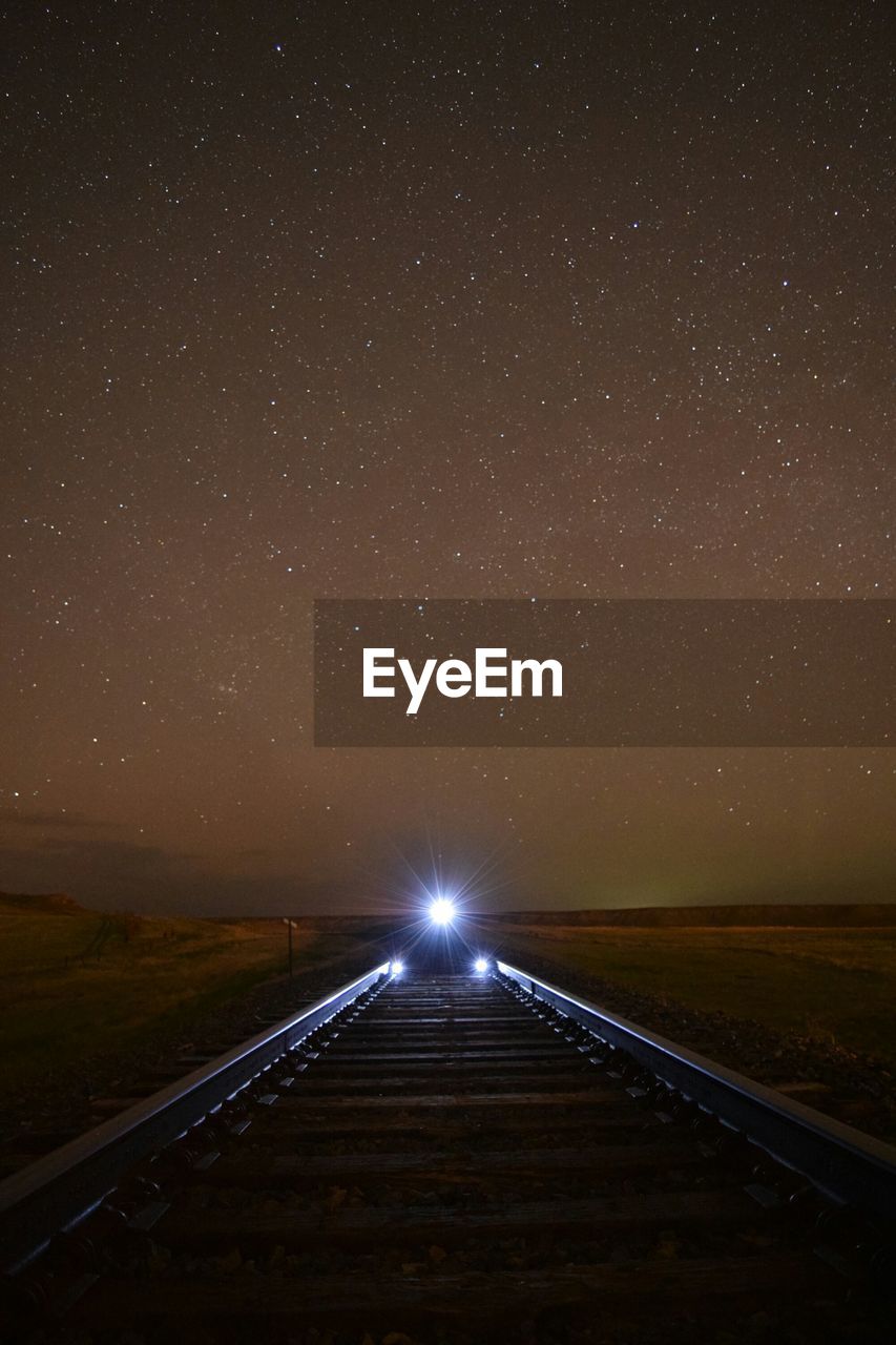 Empty road against sky at night