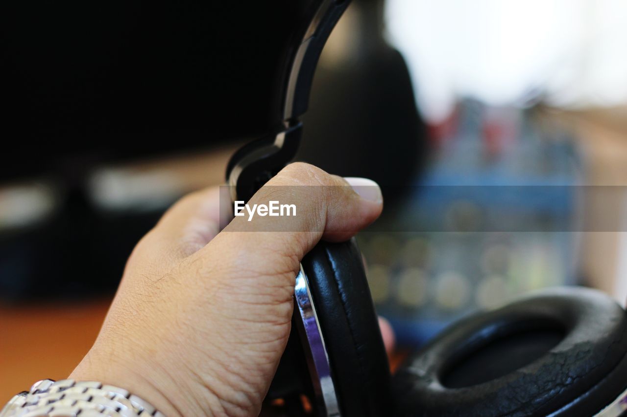 Close-up of hand holding headphones