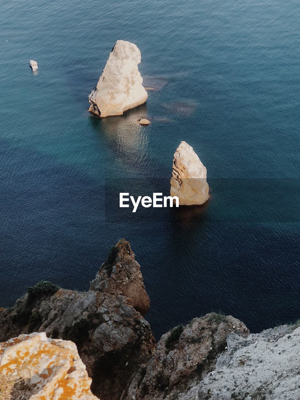 High angle view of rocks on sea shore