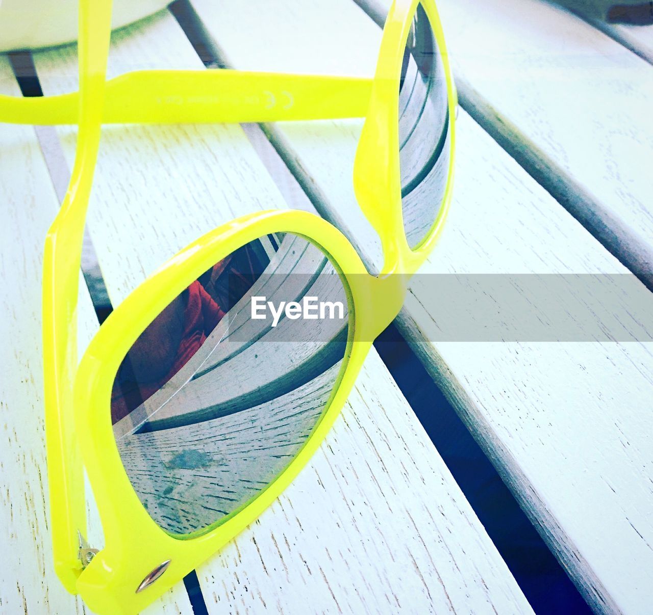 Close-up of sunglasses on bench