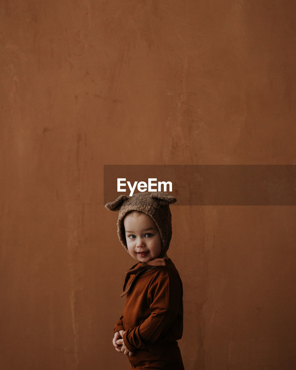 Toddler baby boy in funny costume with ears looking at the camera