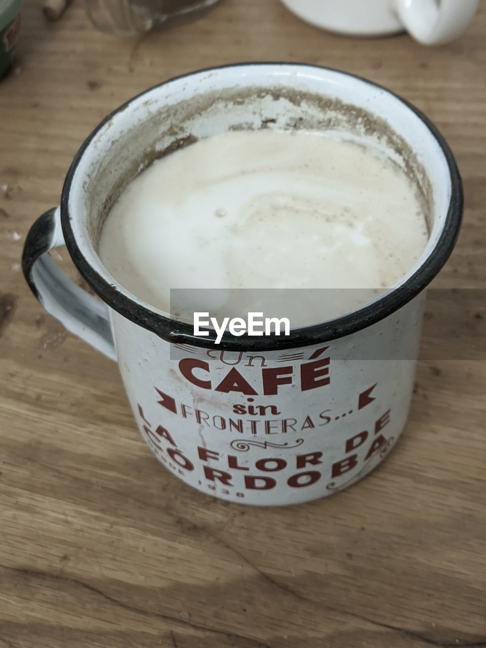 food and drink, drink, table, food, refreshment, indoors, cup, dairy, mug, coffee, breakfast, wood, still life, latte, freshness, no people, coffee cup, hot drink, high angle view, close-up, text, dish, dessert, meal, western script, kitchen utensil, milk, frothy drink