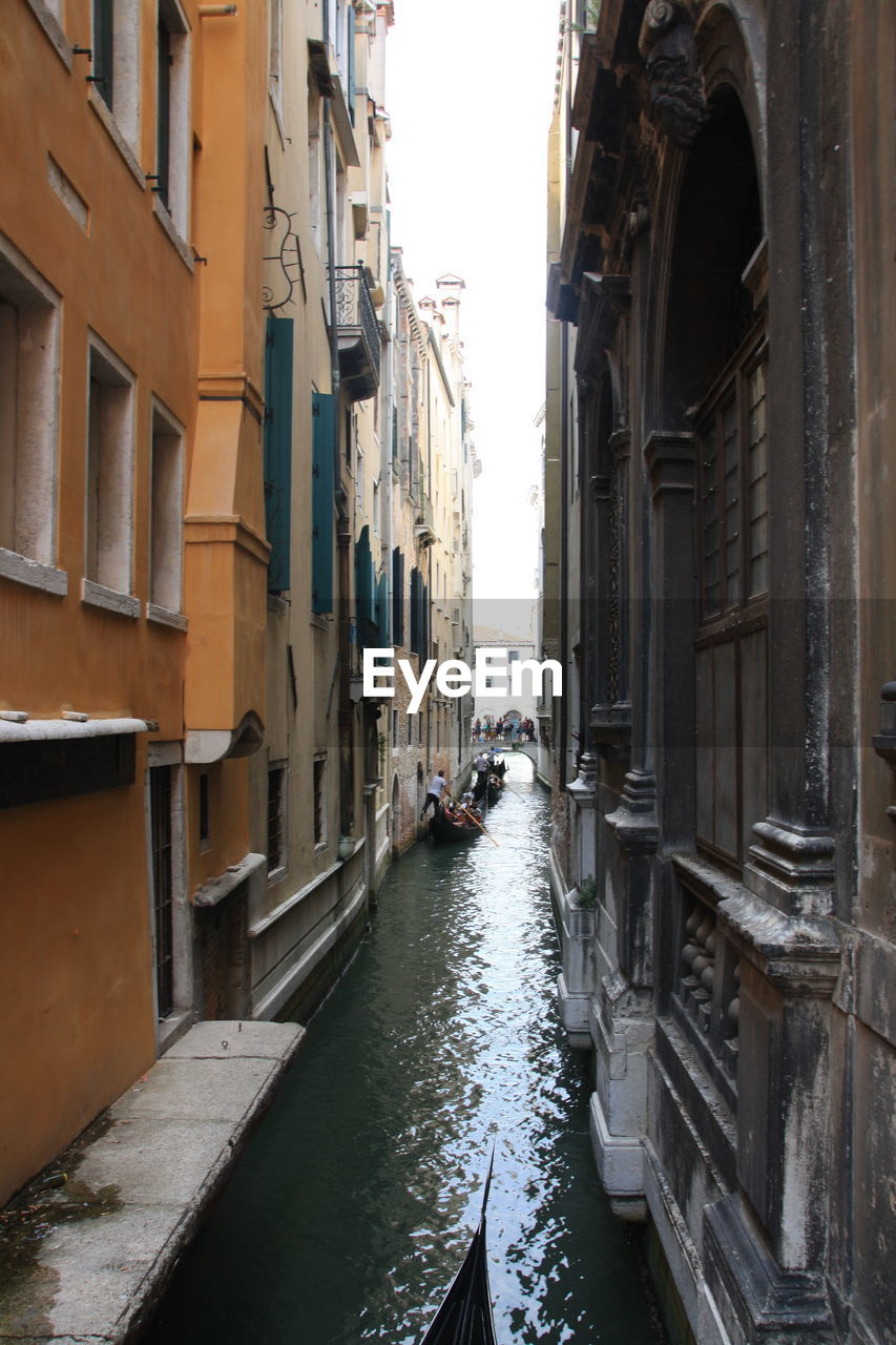 CANAL AMIDST RESIDENTIAL BUILDINGS