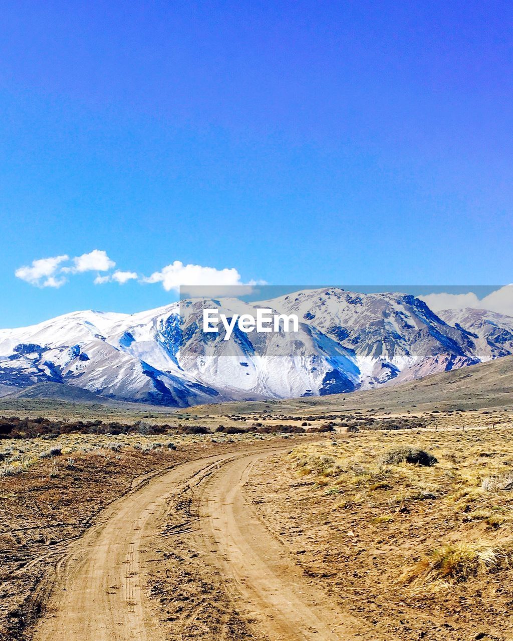 SNOWCAPPED MOUNTAINS AGAINST BLUE SKY